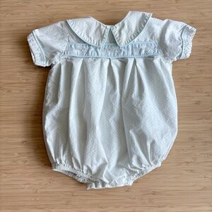 white train baby romper with blue accents